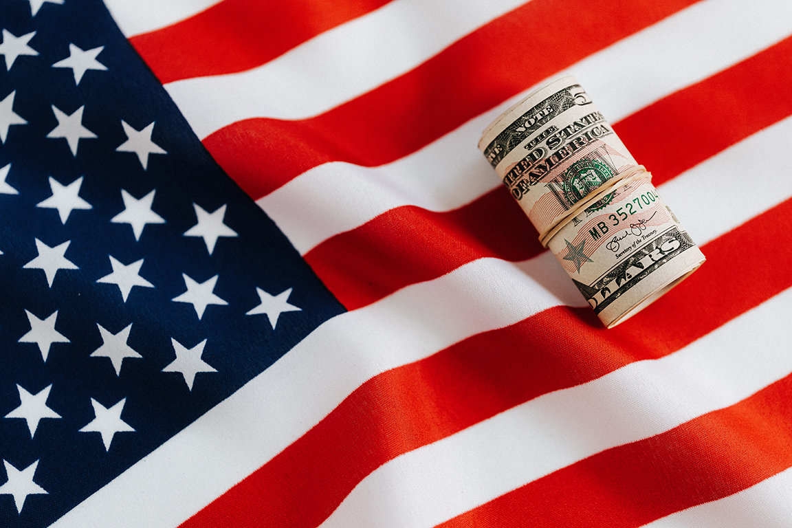 American flag with money on top of it
