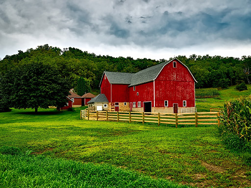 Picture of a red barn in a field.